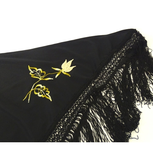 881 - A Victorian black fringed shawl with floral embroidery.