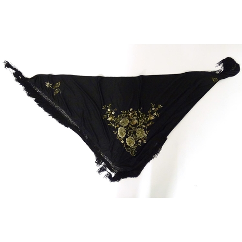 881 - A Victorian black fringed shawl with floral embroidery.