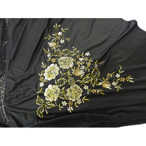 881 - A Victorian black fringed shawl with floral embroidery.