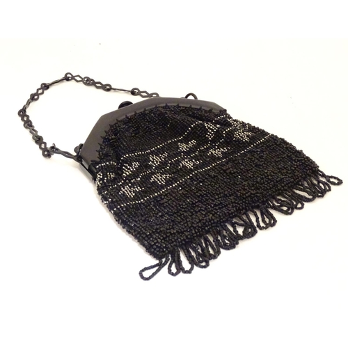 882 - A 20thC bead work bag /purse with banded detail. Approx. 7