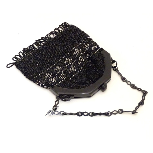 882 - A 20thC bead work bag /purse with banded detail. Approx. 7