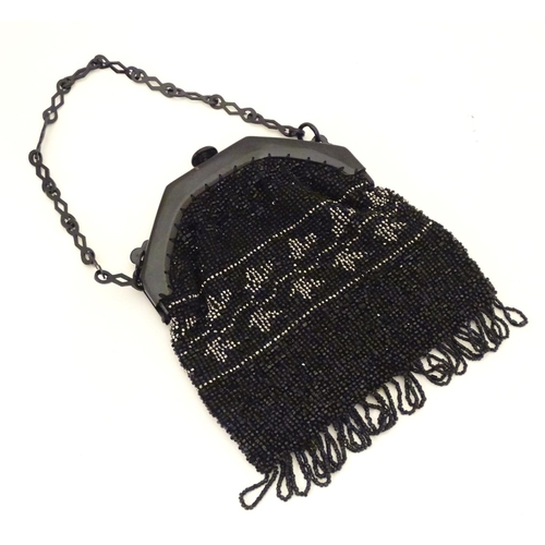 882 - A 20thC bead work bag /purse with banded detail. Approx. 7