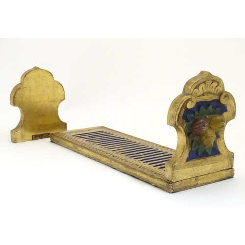 886 - An Italian style carved book slide with gilt and polychrome decoration, the supports decorated with ... 