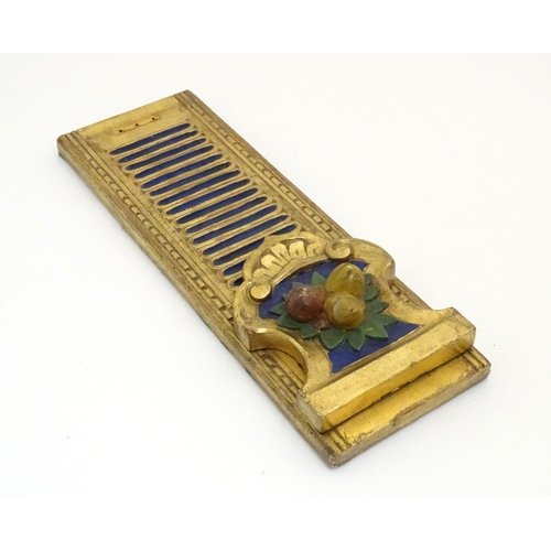 886 - An Italian style carved book slide with gilt and polychrome decoration, the supports decorated with ... 