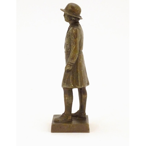 887 - A 20thC cast bronze model of a Girl Guide wearing a hat and uniform, on a square base. Approx. 6