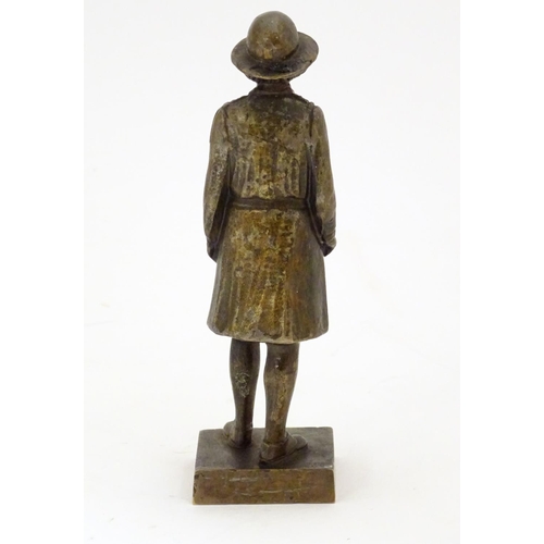 887 - A 20thC cast bronze model of a Girl Guide wearing a hat and uniform, on a square base. Approx. 6