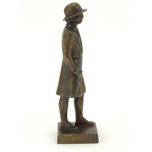 887 - A 20thC cast bronze model of a Girl Guide wearing a hat and uniform, on a square base. Approx. 6