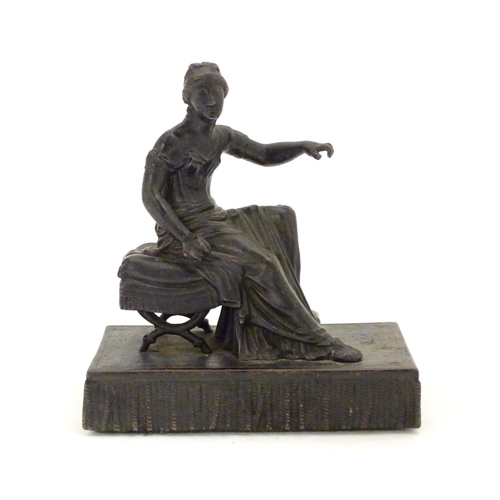 892 - A 19thC bronze figure of a woman seated on an x-frame stool mounted on a fringed rectangular base. A... 