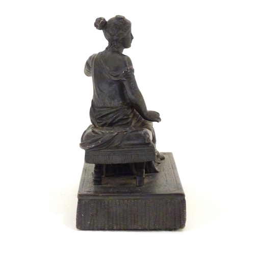 892 - A 19thC bronze figure of a woman seated on an x-frame stool mounted on a fringed rectangular base. A... 