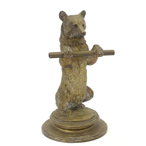 895 - A Victorian novelty brass desk inkwell / standish modelled as a standing bear holding a staff, his h... 