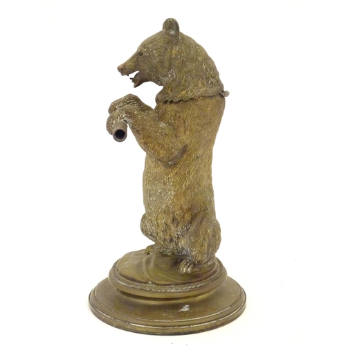 895 - A Victorian novelty brass desk inkwell / standish modelled as a standing bear holding a staff, his h... 