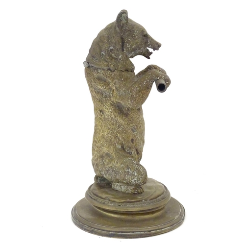 895 - A Victorian novelty brass desk inkwell / standish modelled as a standing bear holding a staff, his h... 