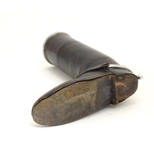 901 - A 20thC table lighter modelled as a riding boot with a leather finish. Approx. 6 1/4