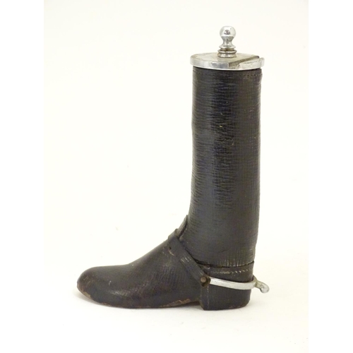 901 - A 20thC table lighter modelled as a riding boot with a leather finish. Approx. 6 1/4