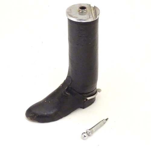 901 - A 20thC table lighter modelled as a riding boot with a leather finish. Approx. 6 1/4