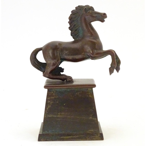 902 - An early 20thC bronze model of a rearing horse, on a tapered plinth base. Approx. 5 3/4