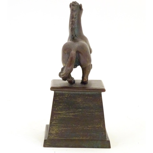 902 - An early 20thC bronze model of a rearing horse, on a tapered plinth base. Approx. 5 3/4