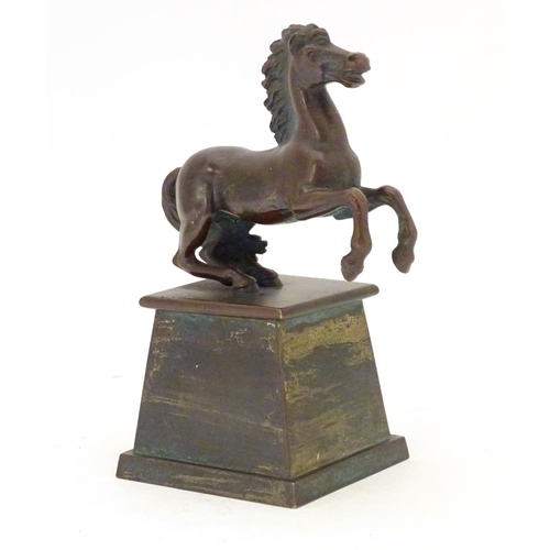 902 - An early 20thC bronze model of a rearing horse, on a tapered plinth base. Approx. 5 3/4