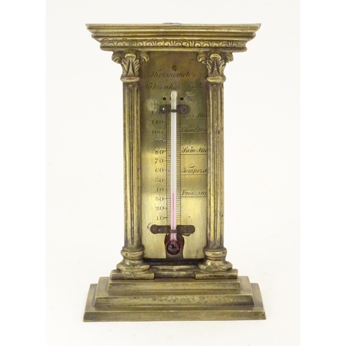 906 - A late 19th / early 20thC brass table top thermometer with a fahrenheit scale within an architectura... 