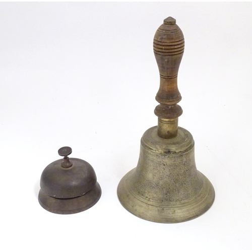 909 - Two late 19th / early 20thC bells comprising a counter / desk bell and a brass hand bell with a turn... 