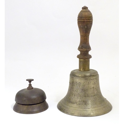 909 - Two late 19th / early 20thC bells comprising a counter / desk bell and a brass hand bell with a turn... 