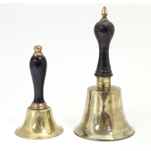 911 - Two early 20thC brass hand bells with ebonised and turned handles. Largest approx. 7