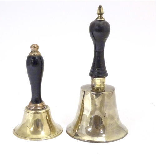 911 - Two early 20thC brass hand bells with ebonised and turned handles. Largest approx. 7