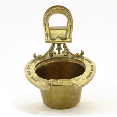 920 - A 19thC brass smoker's companion, comprising ashtray and vesta holder with cast horse shoe and stirr... 