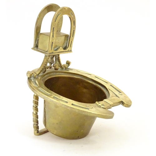 920 - A 19thC brass smoker's companion, comprising ashtray and vesta holder with cast horse shoe and stirr... 