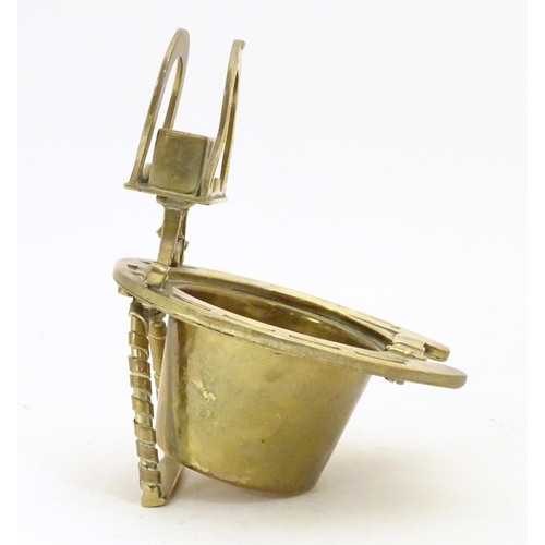 920 - A 19thC brass smoker's companion, comprising ashtray and vesta holder with cast horse shoe and stirr... 