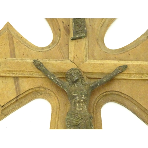 924 - An early 20thC wooden crucifix with a cast model of Jesus Christ on the cross below an INRI scroll m... 