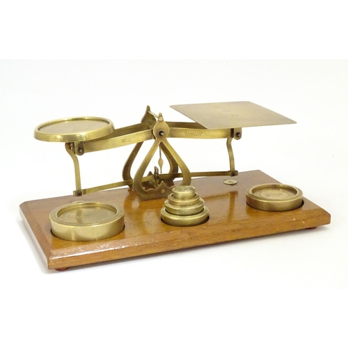 926 - A set of Victorian brass postal scales with six graduated weights. Approx. 10