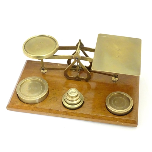 926 - A set of Victorian brass postal scales with six graduated weights. Approx. 10