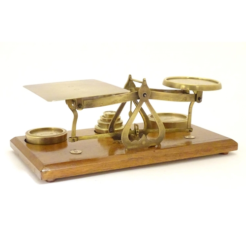 926 - A set of Victorian brass postal scales with six graduated weights. Approx. 10