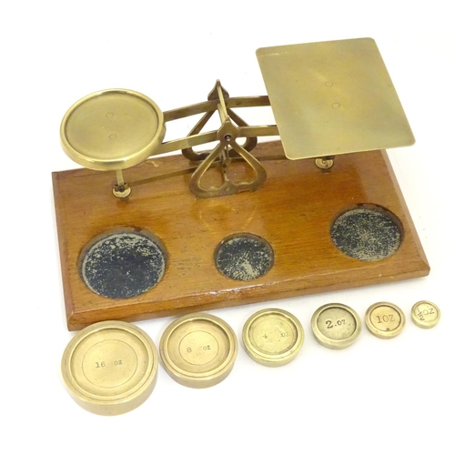 926 - A set of Victorian brass postal scales with six graduated weights. Approx. 10