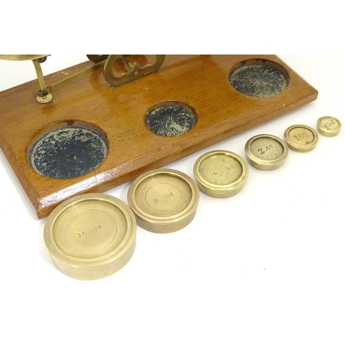 926 - A set of Victorian brass postal scales with six graduated weights. Approx. 10