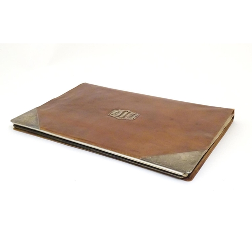 928 - An early 20thC large silver mounted leather desk stationary blotter of folding rectangular form, the... 