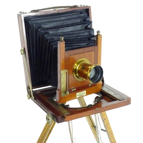 940 - A c1900 plate camera, of mahogany construction, bearing an ivorine plaque inscribed 'The Society - T... 