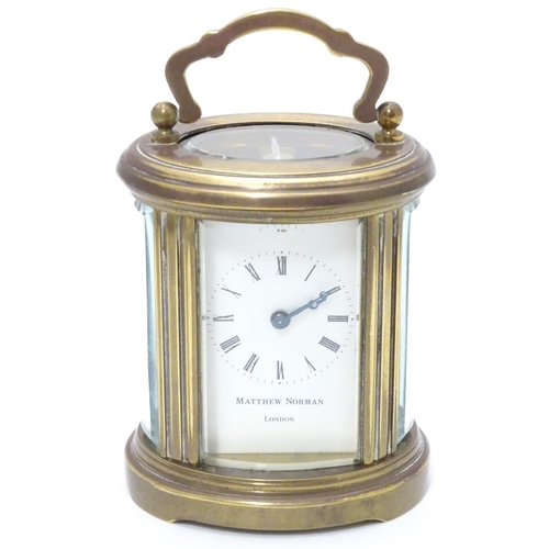 1177 - A late 20th Century small carriage clock by Matthew Norman , London.  With oval brass case, the whit... 