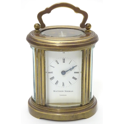 1177 - A late 20th Century small carriage clock by Matthew Norman , London.  With oval brass case, the whit... 