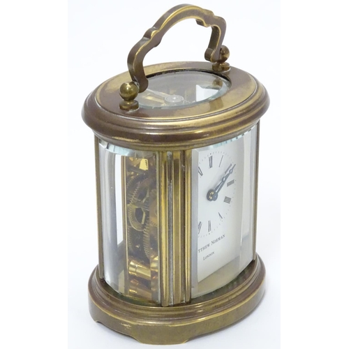 1177 - A late 20th Century small carriage clock by Matthew Norman , London.  With oval brass case, the whit... 