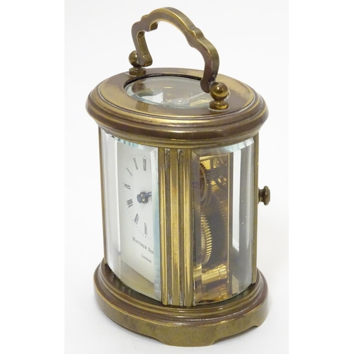 1177 - A late 20th Century small carriage clock by Matthew Norman , London.  With oval brass case, the whit... 