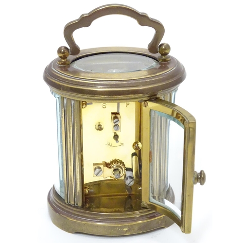 1177 - A late 20th Century small carriage clock by Matthew Norman , London.  With oval brass case, the whit... 