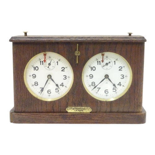 1183 - A 1920's / 30's oak cased chess clock by HAC Hamburg American Clock Company with crossed arrows trad... 