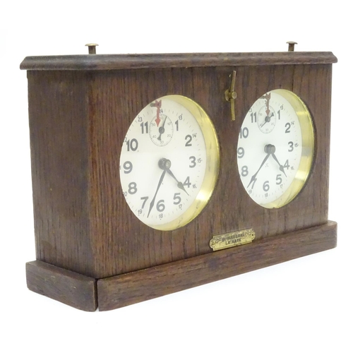 1183 - A 1920's / 30's oak cased chess clock by HAC Hamburg American Clock Company with crossed arrows trad... 