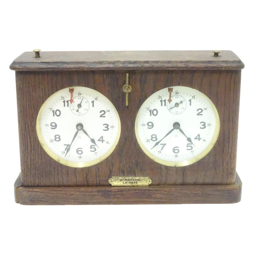 1183 - A 1920's / 30's oak cased chess clock by HAC Hamburg American Clock Company with crossed arrows trad... 