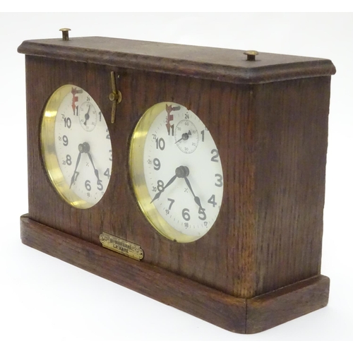 1183 - A 1920's / 30's oak cased chess clock by HAC Hamburg American Clock Company with crossed arrows trad... 