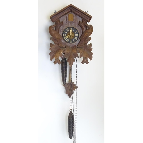 1186 - A mid - late 20thC cuckoo clock, with  ' Regula 'movement and 2 cast pine cone fomred weights. Retai... 