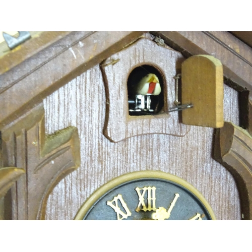 1186 - A mid - late 20thC cuckoo clock, with  ' Regula 'movement and 2 cast pine cone fomred weights. Retai... 