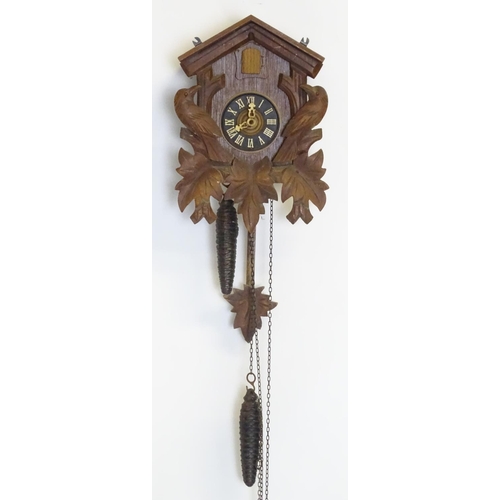 1186 - A mid - late 20thC cuckoo clock, with  ' Regula 'movement and 2 cast pine cone fomred weights. Retai... 